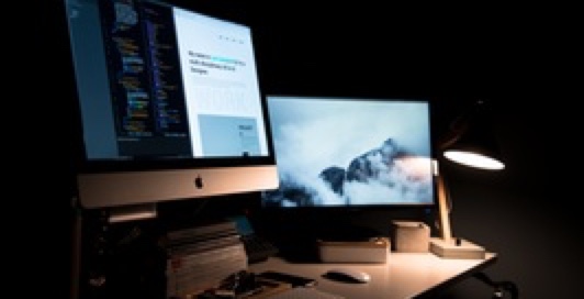 two computer monitors on a desk
